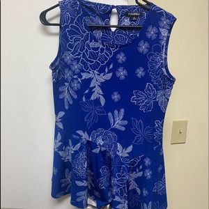 Sleeveless blue and white asymmetrical ruffled top.